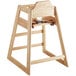 A Lancaster Table & Seating wooden high chair with a seat and back and a strap.