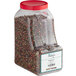 A plastic container of Regal Gourmet Peppercorn Medley with a red lid.