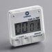 A white Comark digital kitchen timer with a digital display and buttons.