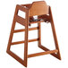 A Lancaster Table & Seating wooden high chair with a seat and back.
