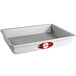 A rectangular silver cake pan with a red and white label.