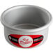 A silver metal Fat Daddio's mini cake pan on a counter with a red and white label.