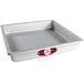 A silver square baking pan with straight sides and a red label.