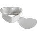 A white heart shaped metal pan with a removable bottom.