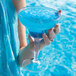 A person holding an Arcoroc SAN plastic margarita glass with blue liquid.