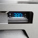 A Beverage-Air reach-in refrigerator with a digital display for temperature on a stainless steel counter.