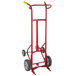A red Wesco Industrial Products 4 wheel steel drum hand truck with rubber wheels.
