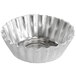 A silver metal round bowl with wavy edges.
