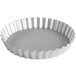 A silver round fluted tart pan with a removable round bottom.