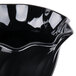 A black Cambro swirl bowl with a wavy design on the edge.