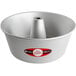 A silver cake pan with a metal top and a white base.
