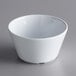 An Acopa Foundations white melamine bouillon bowl on a gray surface.