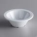 An Acopa Foundations white melamine fruit dish with a white rim on a gray surface.