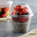 A Fabri-Kal Greenware compostable plastic parfait cup with chia pudding and strawberries.
