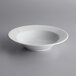 A Corona by GET Enterprises Actualite porcelain bowl on a gray surface.