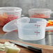A close up of a Cambro translucent round plastic food storage container with a lid.