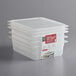 A stack of three Cambro translucent plastic food containers with seal covers.