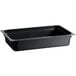 A black rectangular Vigor polycarbonate food pan on a counter.