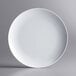 An Acopa Lunar white melamine plate with a white rim on a white background.