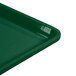 A close up of a green Cambro dietary tray with a handle.