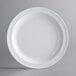An Acopa Foundations white melamine plate with a white rim.