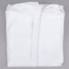 A close-up of a folded white polypropylene coverall