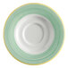 A close-up of a Corona bright white porcelain saucer with a green and yellow rim.