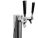 A silver metal Turbo Air beer tap with black handles.