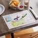 A table with a zoo themed Choice kids placemat and food on it.