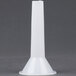 A white plastic funnel with a white cap on a gray surface.
