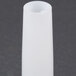 A white plastic cylindrical sausage stuffer tube with a hole in it.
