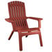 A Grosfillex barn red resin Adirondack chair with armrests.