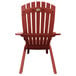 A Grosfillex Westport barn red resin outdoor Adirondack chair with armrests.