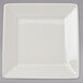 A white square Tuxton china plate with a small square cut out.