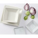 A Tuxton eggshell white square china plate with a red onion and a white square bowl.