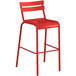 A red Lancaster Table & Seating outdoor bar stool with a metal frame.