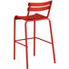 A red Lancaster Table & Seating outdoor barstool with a metal frame.
