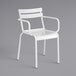 A white Lancaster Table & Seating aluminum arm chair with armrests.