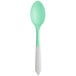 A white dessert spoon with a green and white handle.
