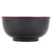 A black melamine bowl with a red rim.