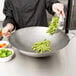 A chef using a Town Hand Hammered Cantonese Wok to cook green beans.