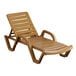 A tan resin chaise lounge chair with arms and a wooden frame.