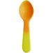 A close up of a yellow and orange plastic tasting spoon.