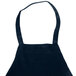 A navy blue Chef Revival bib apron with a pocket and straps.