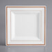 A white square plate with rose gold trim.