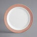 A white plastic plate with rose gold lattice design on it.