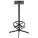 A black steel Holland Bar Stool outdoor bar height table base with a foot ring.