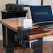 A Luxor KwikBoost EdgePower charging station on a desk with a laptop and charger.