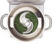 A metal bowl with green grass inside a Robot Coupe food processor.