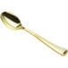A Visions gold plastic spoon with a long handle.